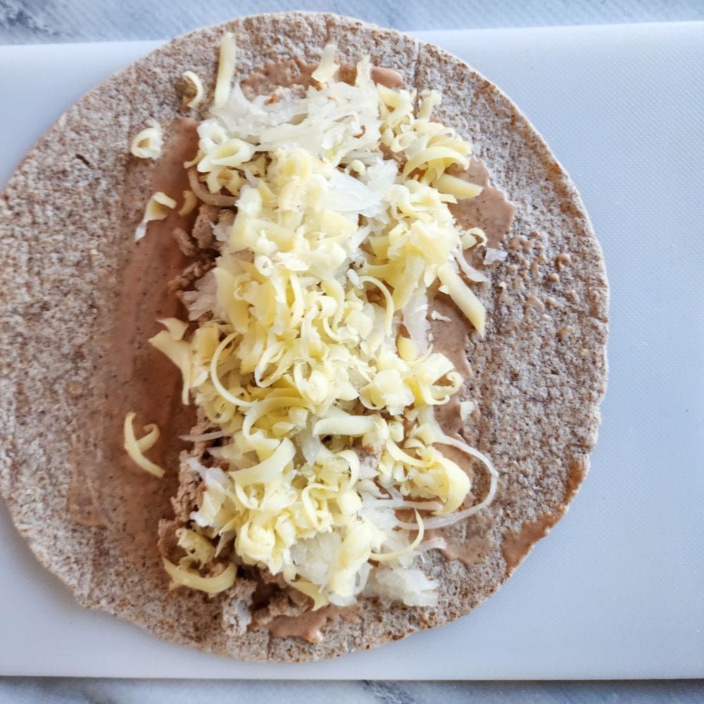 a picture of process step 3, turkey kraut and chees on a tortilla 
