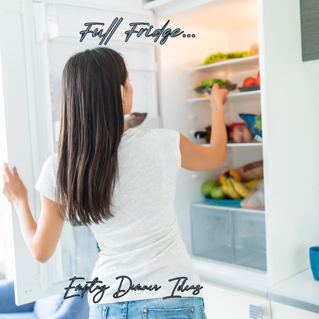 a picture of a lady reaching into a full refrigertor