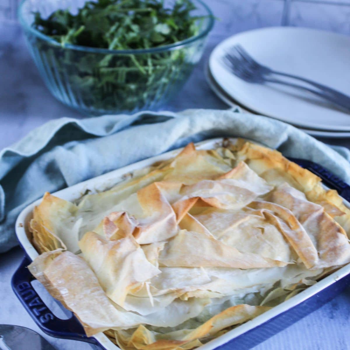 Greek chicken casserole in a casserole dish baked to perfection with a golden brown crust.