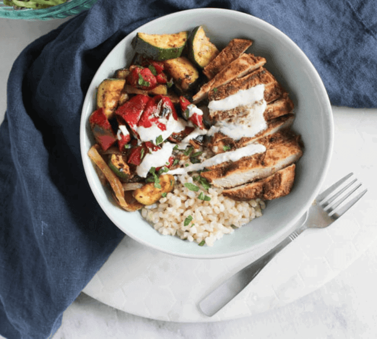 an overhead view of chicken shawarma bowl with fork on the side